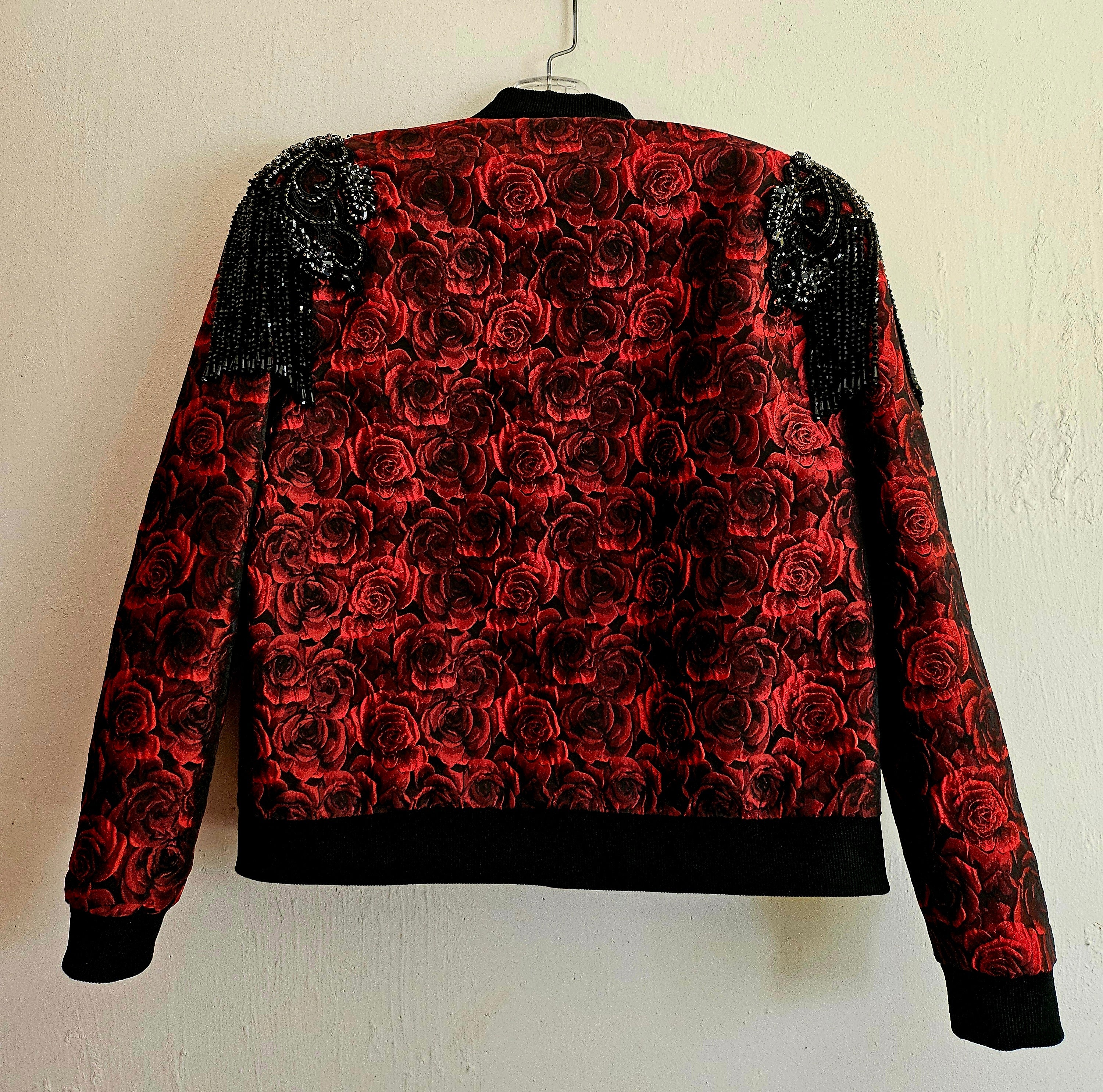 Back view of Red rose brocade bomber jacket with rhinestone appliqued shoulders with beaded fringe.